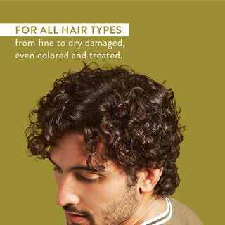 Man with curly hair and text reading “For all hair types from fine to dry damaged, even colored and treated”