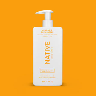 Front of Native Almond & Shea Butter Strengthening Conditioner bottle with orange background