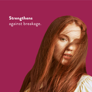 Woman with long red hair with text reading “Locks in moisture and helps strengthen against breakage”