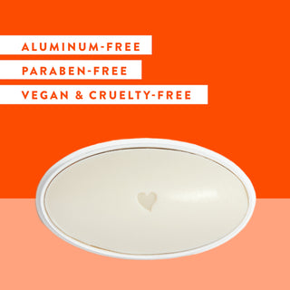 Inside of Native Citrus & Herbal Musk deodorant laid flat on an orange background