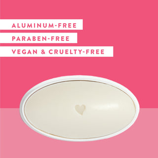 Inside of Native Grapefruit & Bergamot deodorant laid flat on a pink background