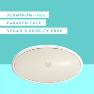 Inside of Native Jasmine & Cedar deodorant laid flat on teal background