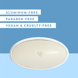 Inside of Native Midnight Jasmine & Sage deodorant laid flat on blue background