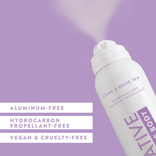 Angled view of Native Whole Body Deodorant in Lilac & White Tea scent spraying, labeled aluminum-free and natural propellant