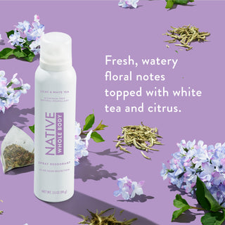 Native Whole Body Deodorant with lilac flowers and white tea leaves on lilac background