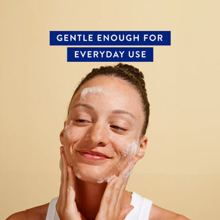 Smiling woman washing her face with Native facial cleanser, with text reading "Gentle Enough for Everyday Use" above