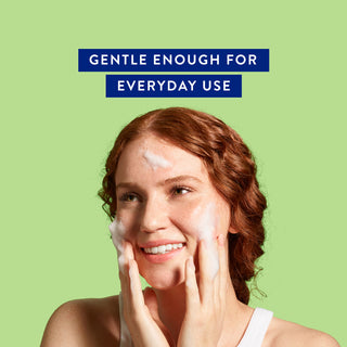 Smiling woman washing her face with Native facial cleanser, with text reading "Gentle Enough for Everyday Use" above