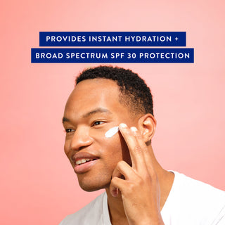 Smiling man applying moisturizer to cheek with text: Provides instant hydration + broad spectrum SPF 30 protection