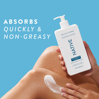 Native Sea Salt & Cedar Moisturizing Lotion bottle being applied to a person's leg, promoting “Absorbs quickly & non-greasy”