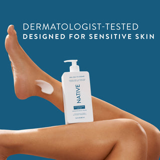 Native Sea Salt & Cedar Moisturizing Lotion bottle on a person’s legs, promoting “Dermatologist-Tested designed for sensitive skin”