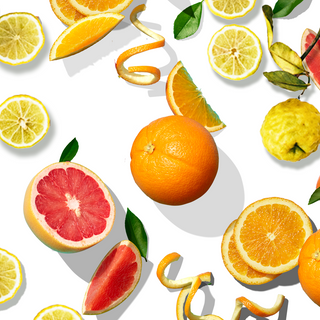 Arrangement of whole orange, blood orange slices, orange slices, thin orange peel, and whole bergamot fruit