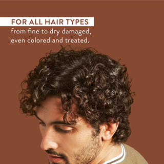 Man with curly hair and text reading “For all hair types from fine to dry damaged, even colored and treated”