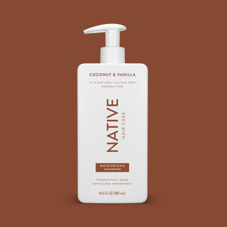 Front of Coconut & Vanilla Moisturizing Shampoo bottle on brown background