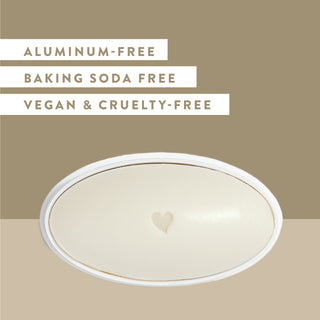 Inside of Native Sandalwood & Shea Butter sensitive deodorant laid flat on green background