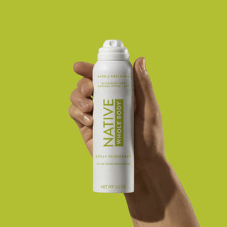 Hand holding Native Aloe & Green Tea Whole Body Deodorant spray